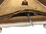 The destroyed front stitched edge.