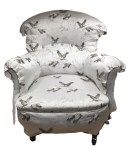 Fabric secured to inner back and arms and buttons in place